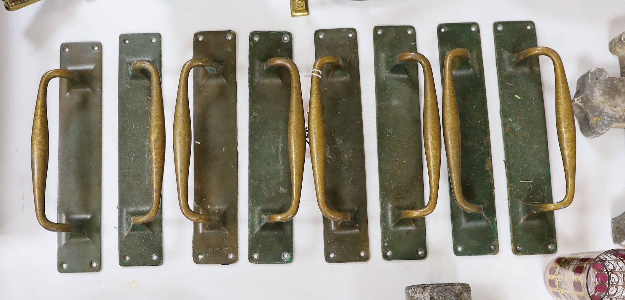 A set of 8 large bronze door handles, 30cm long
